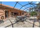 Screened patio with tiled flooring, dining table, and ample seating area for outdoor gatherings at 8445 Lone Eagle Way, Sarasota, FL 34241