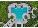 An aerial view of the uniquely shaped pool, palm trees, and surrounding greenery at 8641 Rain Song Rd, Sarasota, FL 34238