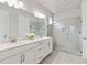 Elegant bathroom featuring a double sink vanity and a spacious glass-enclosed shower at 8641 Rain Song Rd, Sarasota, FL 34238