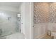 Contemporary bathroom with tiled shower and stylish floral wallpaper at 8641 Rain Song Rd, Sarasota, FL 34238