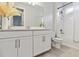 Well-lit bathroom with a double sink vanity, granite countertop, and tub with shower at 8641 Rain Song Rd, Sarasota, FL 34238