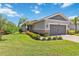 Charming single-story home with manicured lawn, stone accents, and a two-car garage at 8641 Rain Song Rd, Sarasota, FL 34238
