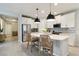 Modern kitchen features stainless steel appliances, pendant lighting, and a center island with seating at 8641 Rain Song Rd, Sarasota, FL 34238