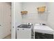 Functional laundry room equipped with modern Maytag washer and dryer at 8641 Rain Song Rd, Sarasota, FL 34238