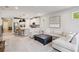Inviting living space featuring a large sectional sofa open to the modern kitchen with island seating at 8641 Rain Song Rd, Sarasota, FL 34238