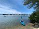 People paddle in kayaks on a sunny day with clear skies, and a scenic waterway at 8641 Rain Song Rd, Sarasota, FL 34238
