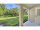 Green backyard and patio of a house with green trees creating a serene retreat perfect for outdoor relaxation and enjoyment at 8907 White Sage Loop, Lakewood Ranch, FL 34202