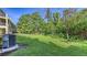 Expansive grassy backyard offering ample space for outdoor activities and relaxation, enhanced by mature trees and landscaping at 8907 White Sage Loop, Lakewood Ranch, FL 34202