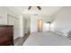 Neutral primary bedroom with double closet, dresser, and access to other rooms at 8907 White Sage Loop, Lakewood Ranch, FL 34202
