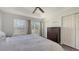Bright bedroom with large windows, a tray ceiling, neutral walls, and a double closet at 8907 White Sage Loop, Lakewood Ranch, FL 34202