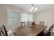 Bright dining area with wood table, chairs and lots of natural light at 8907 White Sage Loop, Lakewood Ranch, FL 34202