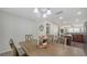 Dining area with a rustic wood table and seamless transition to the adjacent kitchen and living spaces at 8907 White Sage Loop, Lakewood Ranch, FL 34202