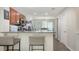 Kitchen featuring breakfast bar seating, modern appliances, and seamless views to the dining area at 8907 White Sage Loop, Lakewood Ranch, FL 34202