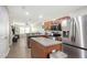 Open-concept kitchen with stainless appliances, center island, that flows into the living area at 8907 White Sage Loop, Lakewood Ranch, FL 34202