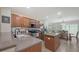 Modern kitchen with stainless steel appliances, island and an adjacent dining area at 8907 White Sage Loop, Lakewood Ranch, FL 34202