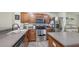 Well-lit kitchen features stainless steel appliances, ample counter space, and center island at 8907 White Sage Loop, Lakewood Ranch, FL 34202