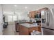 Bright kitchen features stainless steel appliances, a center island, and open concept layout at 8907 White Sage Loop, Lakewood Ranch, FL 34202