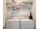 Functional laundry room with a stacked washer and dryer and efficient shelving for organized storage at 8907 White Sage Loop, Lakewood Ranch, FL 34202