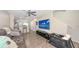 Spacious living area with a modern TV setup and comfortable seating, seamlessly connecting to the kitchen at 8907 White Sage Loop, Lakewood Ranch, FL 34202