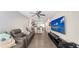 Open living room with a modern entertainment center and comfortable seating that adjoins to the kitchen area at 8907 White Sage Loop, Lakewood Ranch, FL 34202