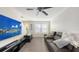 Bright living area with a modern entertainment setup, comfortable seating, and ample natural light at 8907 White Sage Loop, Lakewood Ranch, FL 34202