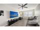 Comfortable living room featuring a ceiling fan, ample natural light, and stylish, modern decor at 8907 White Sage Loop, Lakewood Ranch, FL 34202