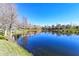 Scenic view of a pond reflecting nearby buildings and trees on a clear day at 8907 White Sage Loop, Lakewood Ranch, FL 34202