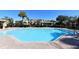 Inviting community pool with clear blue water, surrounded by a brick patio and nearby buildings at 8907 White Sage Loop, Lakewood Ranch, FL 34202