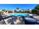 Community pool with lounge chairs, tables, and a clear blue pool for a relaxing day at 8907 White Sage Loop, Lakewood Ranch, FL 34202