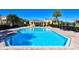 Beautiful community pool with a building nearby and palm trees around, perfect for relaxation at 8907 White Sage Loop, Lakewood Ranch, FL 34202