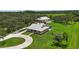 Stunning property featuring a sprawling lawn, main house, and separate large garage/workshop building at 920 Lena Ln, Sarasota, FL 34240