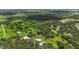 Aerial view of two homes surrounded by lush greenery and a creek at 920 Lena Ln, Sarasota, FL 34240