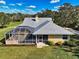 Aerial view of home with a metal roof and a screened-in back porch, all on a large, well-kept lot at 920 Lena Ln, Sarasota, FL 34240