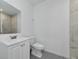Clean bathroom featuring a white vanity, toilet, and a tiled shower with a glass door at 920 Lena Ln, Sarasota, FL 34240