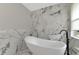 Modern bathroom featuring a freestanding tub, designer tile and large window at 920 Lena Ln, Sarasota, FL 34240