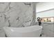 Modern bathroom featuring a freestanding tub, designer tile and large window at 920 Lena Ln, Sarasota, FL 34240