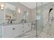 Beautiful bathroom featuring double sinks, white cabinets, granite countertops, and glass enclosed shower at 920 Lena Ln, Sarasota, FL 34240