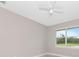 Bright bedroom featuring a ceiling fan and a large window with a scenic view at 920 Lena Ln, Sarasota, FL 34240