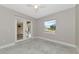 Neutral bedroom featuring light grey walls, white trim and baseboards, and porcelain tiled floor at 920 Lena Ln, Sarasota, FL 34240