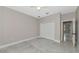 Neutral bedroom with light grey walls, white trim, ceiling fan, closet, and porcelain tiled floor at 920 Lena Ln, Sarasota, FL 34240