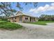 Spacious home with lush lawn, stone accents, and a gravel driveway at 920 Lena Ln, Sarasota, FL 34240