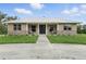 Charming home with stone accents, well-manicured lawn, and inviting covered front porch at 920 Lena Ln, Sarasota, FL 34240