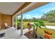 Cozy front porch with decorative plants and a chair that overlooks the beautiful front yard at 920 Lena Ln, Sarasota, FL 34240