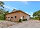 Exterior view of a large, detached garage with multiple bays and ample parking at 920 Lena Ln, Sarasota, FL 34240