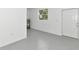Clean garage features painted walls, a window for natural light, and an exterior door to the backyard at 920 Lena Ln, Sarasota, FL 34240