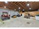 Spacious garage interior with tractor, ATV, lawnmower, shelving, and a well-lit atmosphere at 920 Lena Ln, Sarasota, FL 34240