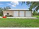 Large detached garage with 3 bays, grass lawn, and ample parking at 920 Lena Ln, Sarasota, FL 34240
