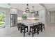 Modern kitchen with large island, stainless steel appliances, and stylish pendant lighting at 920 Lena Ln, Sarasota, FL 34240
