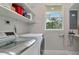 Well lit laundry room with LG washer and dryer, built-in shelves, and window with a view at 920 Lena Ln, Sarasota, FL 34240