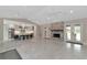 Spacious living room with fireplace, open to a modern kitchen and access to outdoor living space at 920 Lena Ln, Sarasota, FL 34240